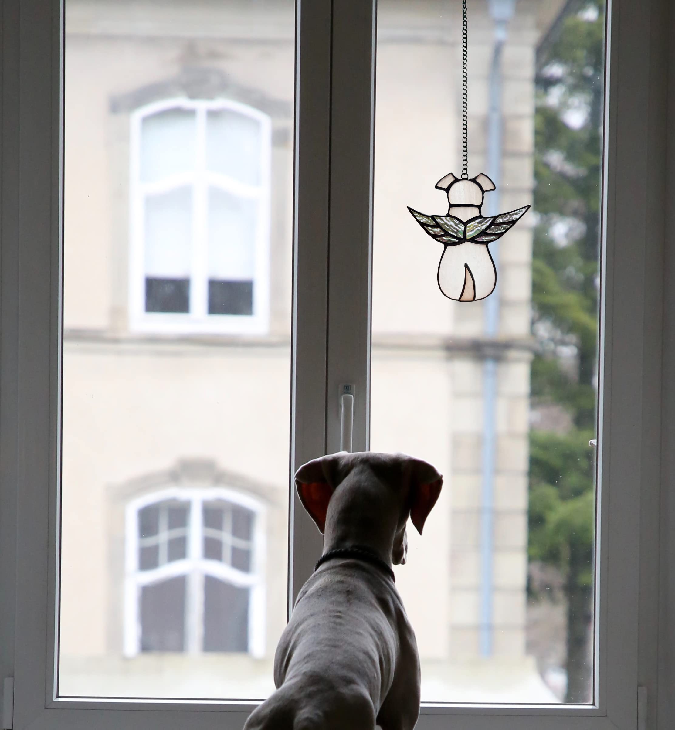 ZUAJITER hand-cut glass dog keepsake glows in sunlight, bringing a gentle tribute to cherished pets